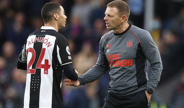Newcastle United caretaker Graeme Jones shakes hands with Miguel Almiron after the Premier League match at Selhurst Park. (Reuters/Action Images)