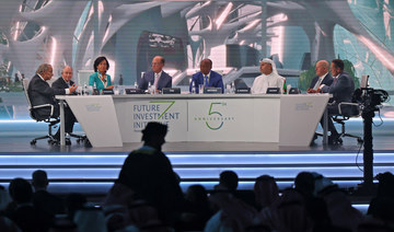 CNN's Richard Quest (L) moderates a session at the annual Future Investment Initiative (FII) conference in the Saudi capital Riyadh on October 26, 2021. (AFP)
