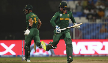South Africa's Rassie van der Dussen, right, and South Africa's Aiden Markram run between the wickets during the Cricket Twenty20 World Cup match between England and South Africa in Sharjah. (AP)