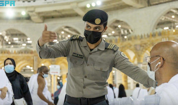 Qualified individuals manage the entry of people through the gates of the Grand Mosque. (SPA)