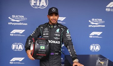 Mercedes’ British driver Lewis Hamilton poses after winning the qualifying session for Brazil’s Formula One Sao Paulo Grand Prix. (AFP)