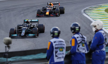 Mercedes' Veltteri Bottas, left, and Red Bull's Max Verstappen steer their car during the Sprint Race qualifying session at the Interlagos racetrack in Sao Paulo. (AP)