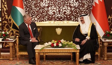 Jordan’s King Abdullah II (L) meets with Bahrain’s King Hamad upon his arrival at the Sakhir Air Base on Nov. 22, 2021. (Jordanian Royal Palace/Yousef Allan/AFP)