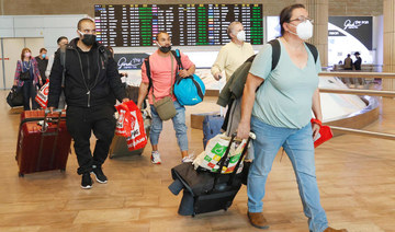  In this file photo taken on November 01, 2021 passengers walk with their luggage upon their arrival at Ben Gurion Airport near Lod, as Israel reopens to tourists vaccinated against Covid-19. (AFP)