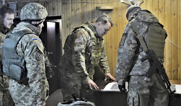 Attache of the Land Forces at the US Embassy in Ukraine Colonel Brandon Presley looks at the map during the visit by a delegation of the US Embassy in Ukraine. (AP file photo)