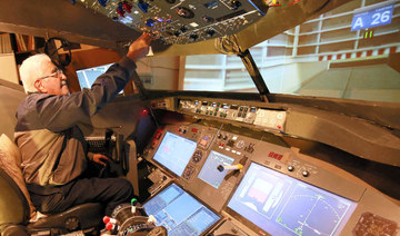  Muhammad Malhas, 76, operates his flight simulator cockpit at his home in Jordan's capital Amman on November 8, 2021. (AFP)