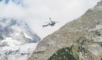 A picture taken on August 10, 2018 shows a helicopter flying over the Mont Blanc massif, on the Italian side of the Alps. (AFP) 