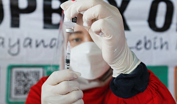A healthcare worker prepares a dose of China's Sinovac Biotech vaccine against the coronavirus disease (COVID-19) during a mass vaccination program for scavengers in Jakarta, Indonesia, December 10, 2021. (REUTERS)