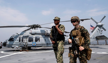US Navy personnel walk past a Sikorsky MH-60 Seahawk helicopter after the USS Blue Ridge docked during a visit in Manila Bay. (AFP file photo)