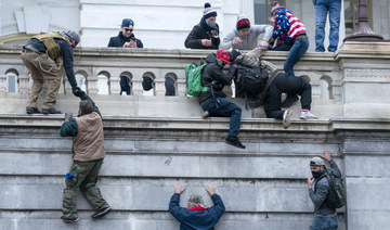 Insurrections loyal to President Donald Trump climb the west wall of the the U.S. Capitol, Jan. 6, 2021, in Washington. (AP)