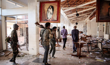 Amhara Fano militia fighters walk in the ransacked terminal at the Lalibela airport in Lalibela, on December 7, 2021. (AFP)