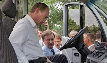 Russian President Vladimir Putin sits in a cab during his visit to an agriculture exhibition in Rostov-on-Don, 30 June 2007. (AFP)