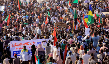 Protesters march during a rally from Khartoum North to Omdurman against military rule following last month's coup, in Khartoum, Sudan. December 13,2021. (REUTERS)