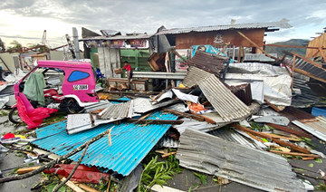This photo taken on December 17, 2021 shows a resident salvaging belongings among debris caused by Super Typhoon Rai after the storm crossed over Surigao City in Surigao del Norte province. (AFP)