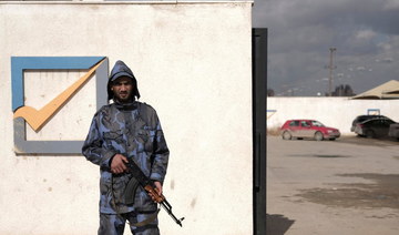 A security officer stands in front of the High National Election Commission building in Benghazi, Libya December 16, 2021. (Reuters)