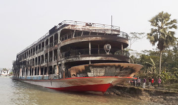 The burnt-out ferry is seen anchored along a coast a day after it caught fire killing at least 39 people in Jhalkathi, 250 km south of Dhaka on December 24, 2021. (AFP)
