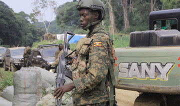 In this file photo taken on December 10, 2021 a soldier with the Uganda People's Defence Forces (UPDF) is seen at a checkpoint on the Mbau-Kamango road in the territory of Beni. (AFP)