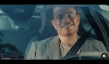 In the commercial for the French car company, Citroen, the Amr Diab is seen tapping his vehicle’s screen to take a photo of a woman crossing the street. (Screenshot)