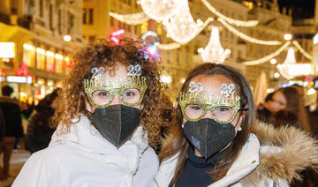 Revelers wait to welcome the new year in Vienna on Friday. (AFP)
