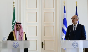 Saudi Foreign Minister Prince Faisal Bin Farhan (L) makes statements with his Greek counterpart Nikos Dendias after their meeting in Athens, Greece, Tuesday, Jan. 4, 2022. (AP)