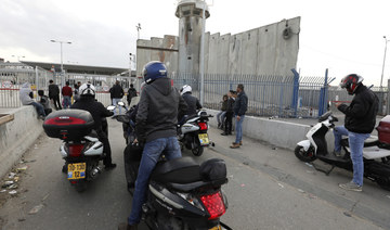  Palestinian cyclists wait at the temporarily closed Qalandia checkpoint on the crossing between the West Bank city of Ramallah and Israeli-occupied east Jerusalemon on December 7, 2020. (AFP)