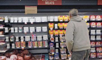 A shopper at a grocery in Pittsburgh looks at the partially empty display of breakfast meats on Tuesday, Jan. 11, 2022. (AP)