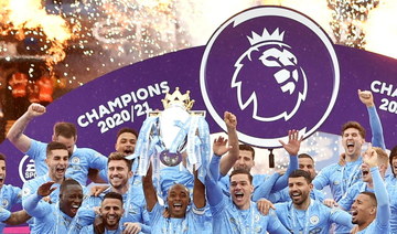 Manchester City’s Fernandinho lifts the trophy as they celebrate winning the Premier League at Etihad Stadium in May 2021. (Reuters)