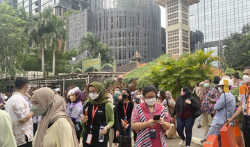 People wait outside as they have to evacuate their office buildings following an earthquake, at the main business district in Jakarta, Indonesia, Friday, Jan. 14, 2022. (AP)