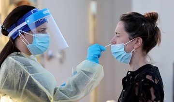 Jordane Domain gets a COVID-19 test done by a healthcare worker on January 13, 2022 in North Miami, Florida. (AFP)