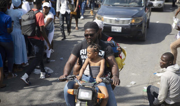 A moto-taxi driver transports customers in Port-au-Prince, Haiti, Friday, Jan. 21, 2022. (AP)