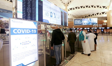 Saudi nationals scan their documents at a digital-Immigration gate at the King Khalid International Airport in Riyadh, Saudi Arabia, May 16, 2021. (REUTERS)