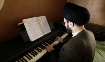 Muslim scholar Sayed Hussein Al-Husseini at the piano at his home in Dahieh, Beirut in 2018. (Reuters/File Photo)