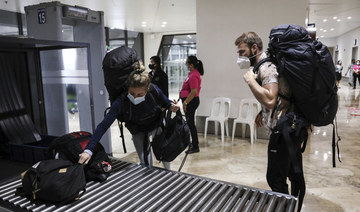 Foreign passengers queue as they arrive at Manila's international airport in the Philippines on Feb. 10, 2022. (AP Photo/Basilio Sepe)