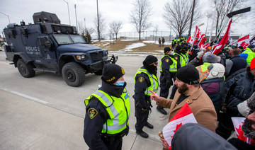 Truckers pull out vehicles from key US-Canadian border bridge, protests swell elsewhere