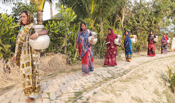 Women carry aluminum pot to fetch safe drinking water for their families in Gabura, an area comprising 15 villages in southern Bangladesh, on Feb. 18, 2022. (Photo courtesy of LEDARS Bangladesh)