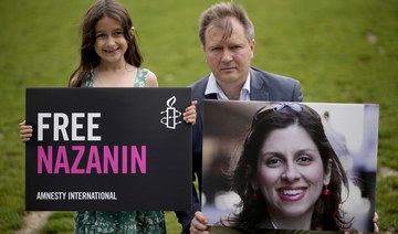 Richard Ratcliffe, husband of imprisoned British-Iranian Nazanin Zaghari-Ratcliffe, and their daughter Gabriella in Parliament Square, London, in September, 2021. (AP/File Photo)