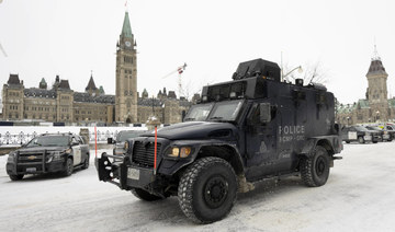 An RCMP tactical vehicle drives past the Parliament buildings, Sunday, Feb. 20, 2022 in Ottawa. (AP)