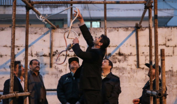 Iranian officials prepare a noose in 2017 (file photo). The country is believed to execute most people per capita, with Iran Human Rights Monitor reporting that 365 prisoners were executed in 2021 alone. (AFP/File Photo)