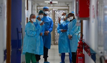 Iraqi medical workers are pictured at the coronavirus ward of Al-Shifa Hospital in the capital Baghdad, on February 20, 2022. Half of the 40 intensive care beds in Baghdad’s Al-Shifa Hospital are occupied. (AFP)