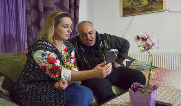 Jordanian student in Ukraine Diana al Awamleh's parents, Wessam al Awamleh and Tatiana al Awamleh, talk to her on the mobile phone in Amman, Jordan February 26, 2022. (REUTERS)