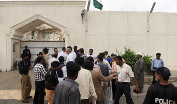 Pakistani security officials gather outside the Saudi consulate in Pakistan's port city of Karachi on May 11, 2011, following a grenade attack. (AFP)