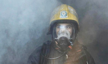 A firefighter from the civil defense team in Hail (northern Saudi Arabia) tries to put out a fire in a factory in October 2020. (Photo/Civil Defense)