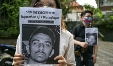 Activists hold placards before submitting a memorandum to parliament in protest of the impending execution of Nagaenthran K. Dharmalingam, sentenced to death for trafficking heroin into Singapore, in Kuala Lumpur. (AFP)