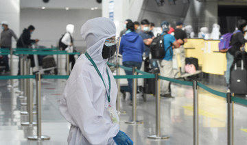 An international airline ground staff wearing protective gear works at the airport in Manila on August 4, 2020. (AFP)