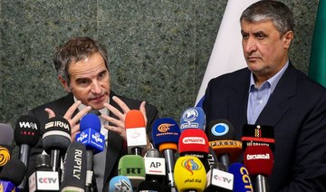 IAEA head Rafael Grossi (L) and head of Iran's Atomic Energy Organization Mohammad Eslami (R) attend a press conference in the capital Tehran. (ISNA via AFP)