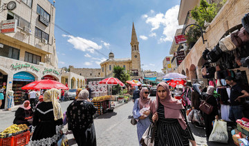 Palestinians shop at a market in the old city of Bethlehem in the occupied West Bank. (AFP file photo)