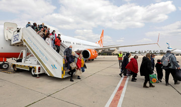Ukrainian Jewish refugees, who fled the war in their country, disembark from a plane upon their arrival at Israel's Ben Gurion Airport in Lod, on March 17, 2022. (AFP)