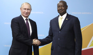 Russian President Vladimir Putin, left, and Ugandan President Yoweri Museveni, right, pose for a photo during their meeting on the sidelines of the Russia-Africa summit in the Black Sea resort of Sochi, Russia on Oct. 23, 2019. (AP)