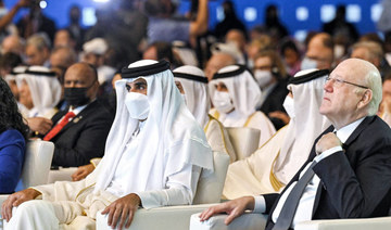 This handout image provided by the Doha Forum shows Qatar's Emir Sheikh Tamim bin Hamad al-Thani (L) and Lebanon's Prime Minister Najib Mikati attending the Doha Forum in Qatar's capital on March 26, 2022. (AFP)