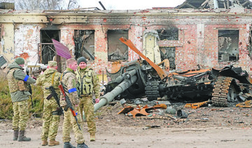 Ukrainian soldiers watch debris from a Russian tank. (AP)